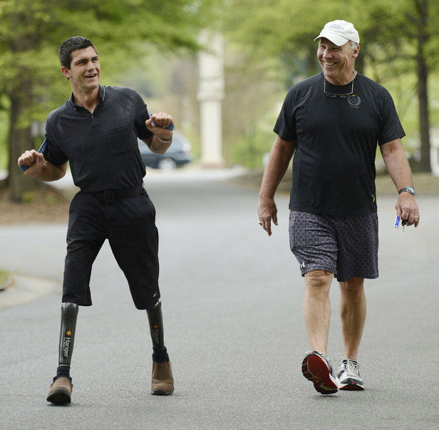 Joe DeLamielleure, right, spends time with Joey Funderburk, who was the inspiration from Joe D's 213-mile charity walk. DeLamiellerure reached the steps of the Pro Football Hall of Fame on Saturday.