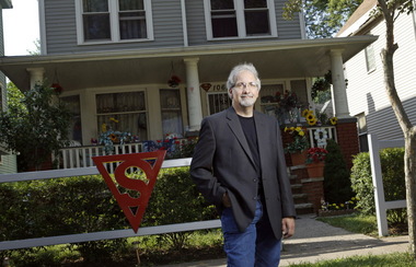 Mike Olszewski stands in front of the childhood home of Jerry Siegel, who co-created Superman as a CLEveland teenager. (Photo by Lonnie Timmons III/The Plain Dealer)