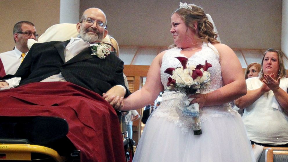 Dying Cleveland Dad Fulfills Promise To Take Daughter Down Aisle. Bride Sarah Nagy, right, begins to cry as she is escorted by her father, Scott, down the aisle during her wedding ceremony, Oct. 12, 2013, at First Lutheran Church in Strongsville. University Hospitals of Cleveland medical staff helped make it happen.